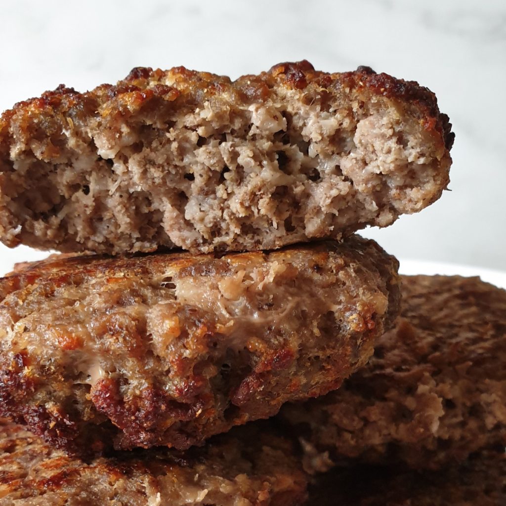 Boerewors patties on a plate showing the inside.