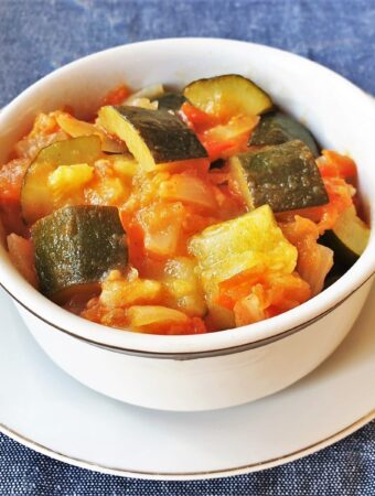 A dish of baby marrows cooked in tomatoes and onions.