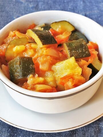 A dish of baby marrows cooked in tomatoes and onions.