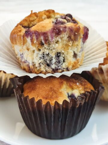 Closeup of a muffin balanced on top of three other muffins.