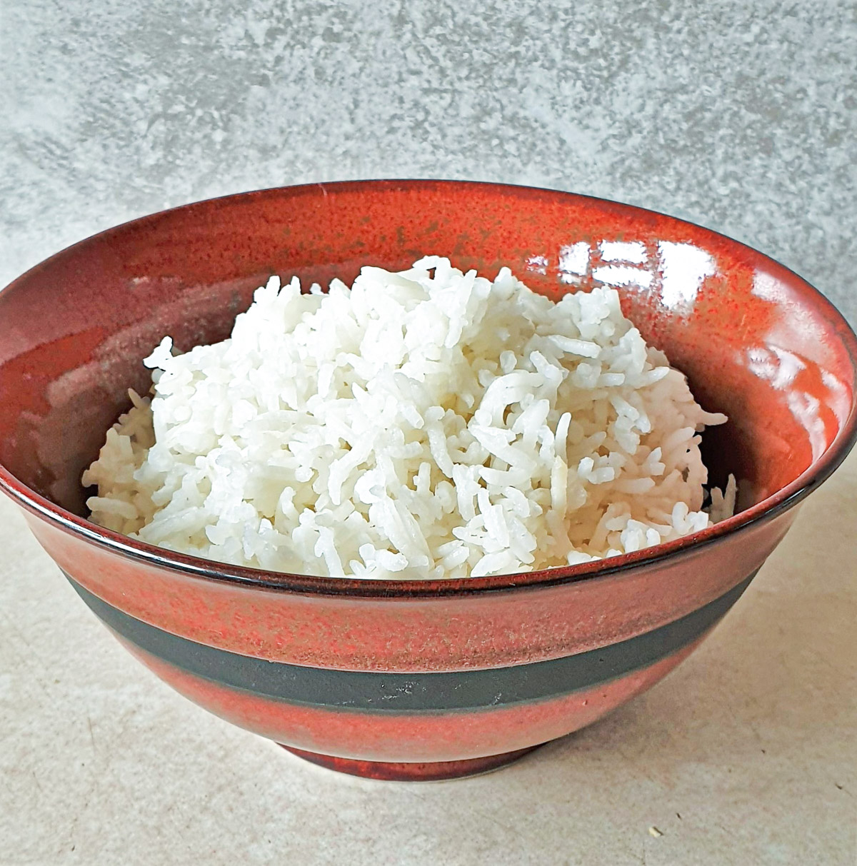 A bowl of white rice cooked in the microwave.