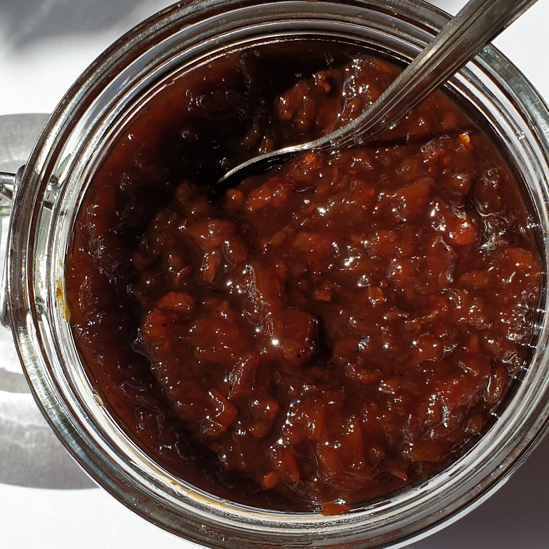 Overhead shot of an open jar of Mrs Balls chutney, showing the texture.