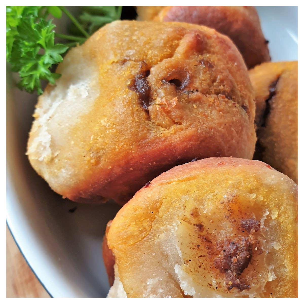 Closeup of a dish of curried dough balls.