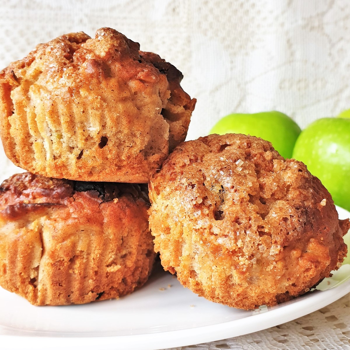 3 apple and oat muffins on a pile.