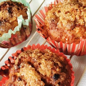 3 apple and oat muffins on a cooling rack.