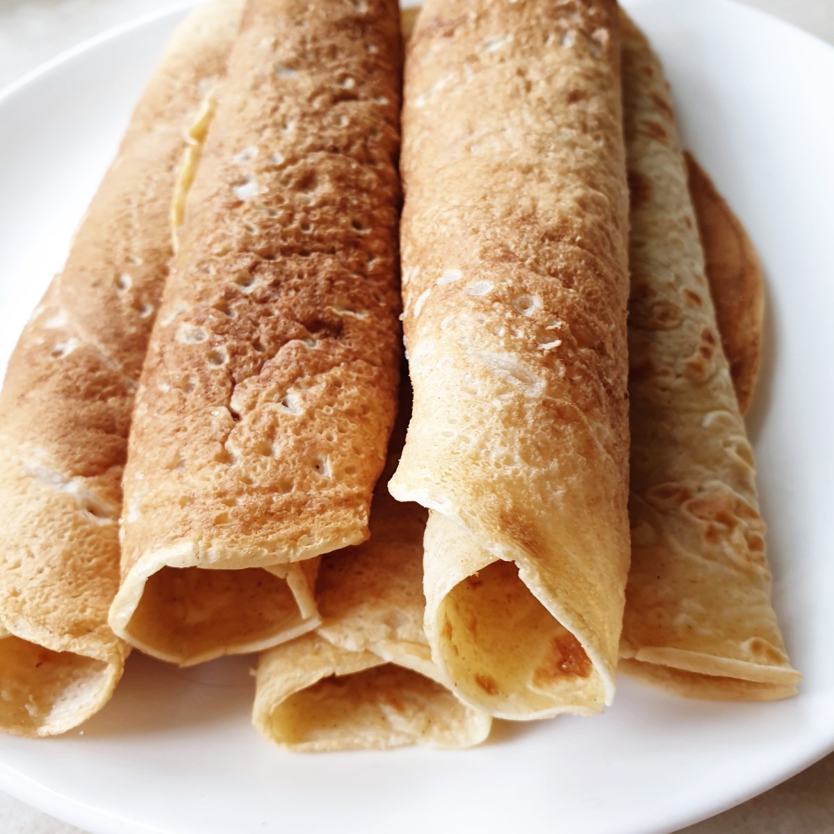 A plate of rolled crepes.