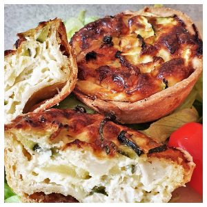 Zucchini and goat cheese tarts on a plate.