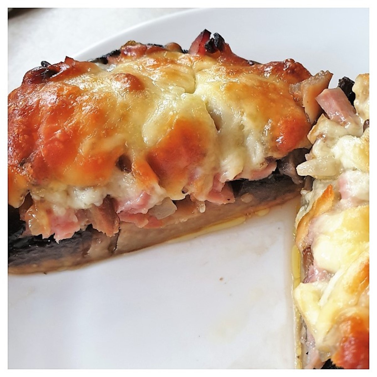 A large stuffed mushroom cut in half to show the inside.