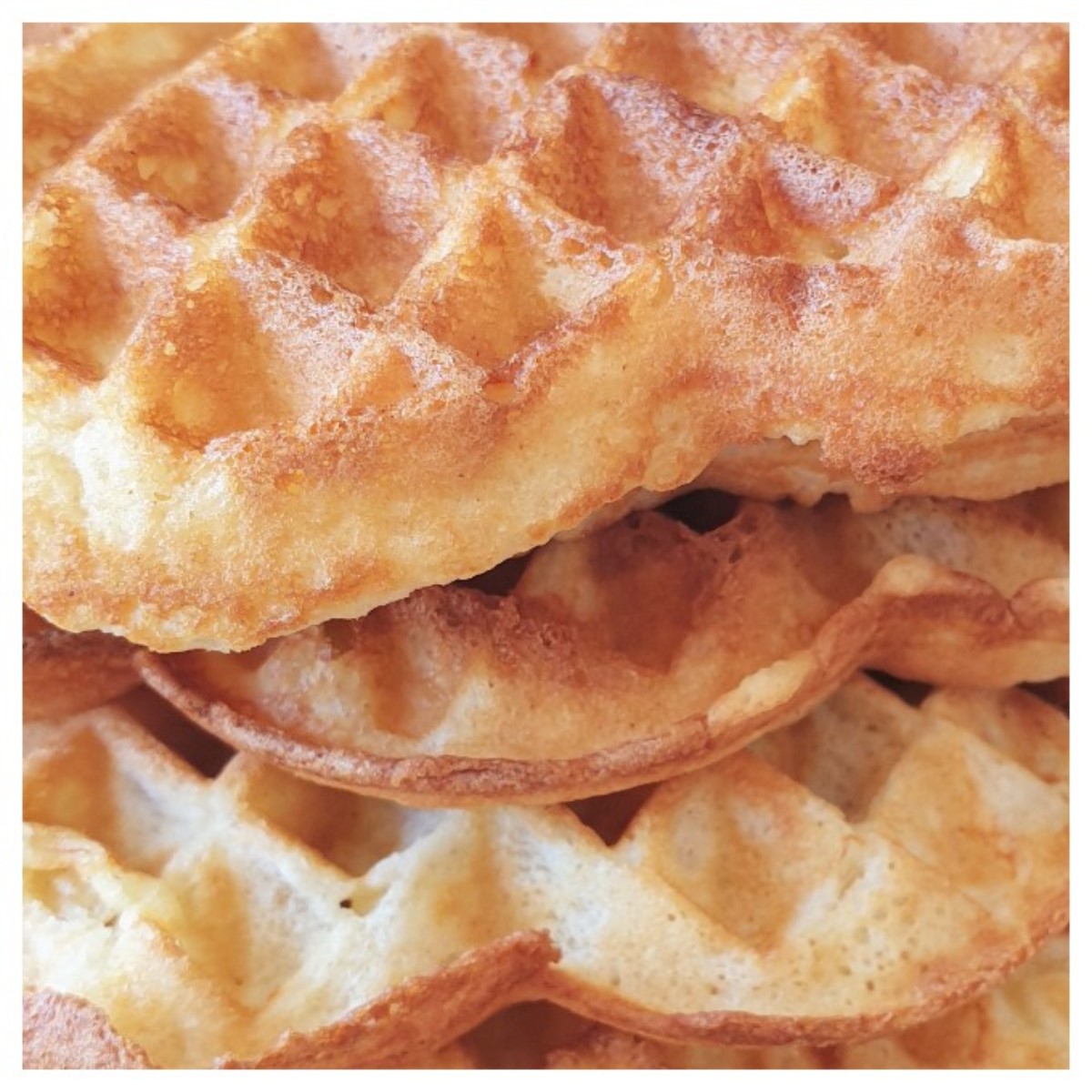 Close up of a pile of waffles showing the texture.