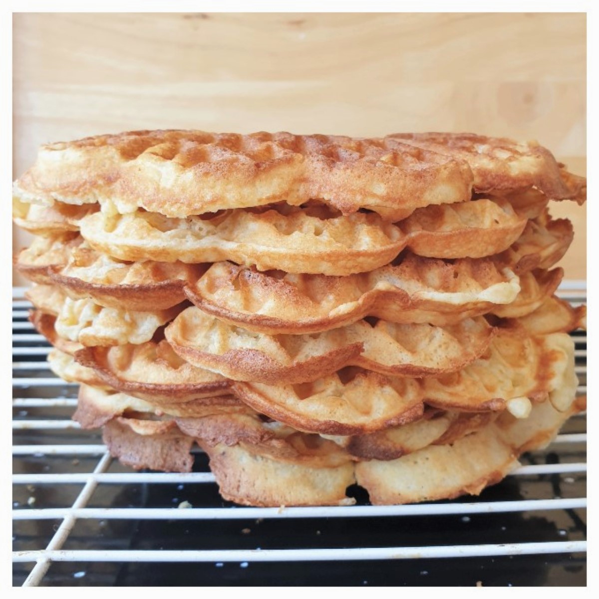 A pile of waffles on a cooling rack.