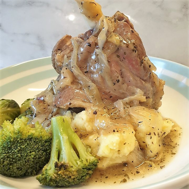 Lamb shank on a plate of mustard mash