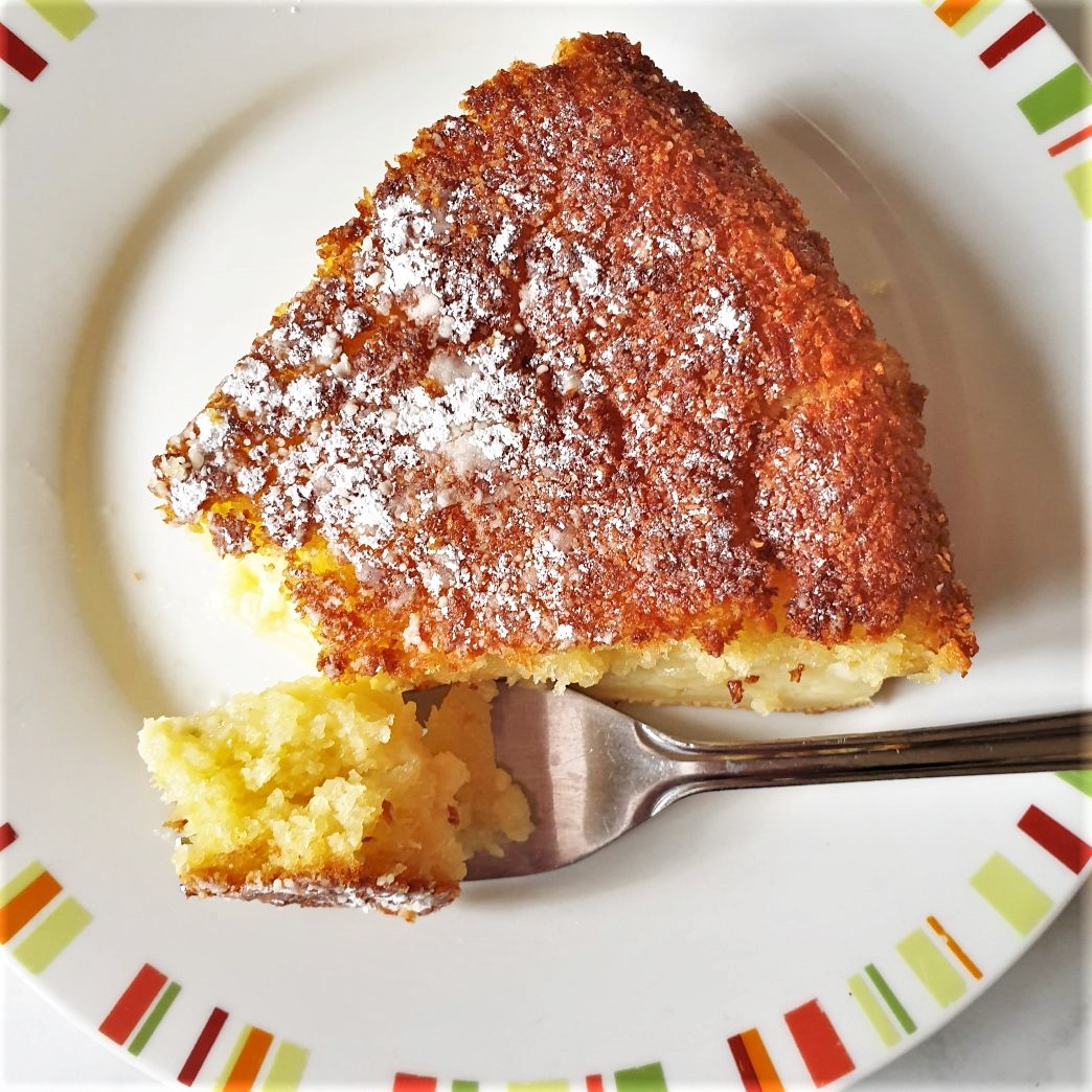 A slice of coconut pie on a plate with a fork.