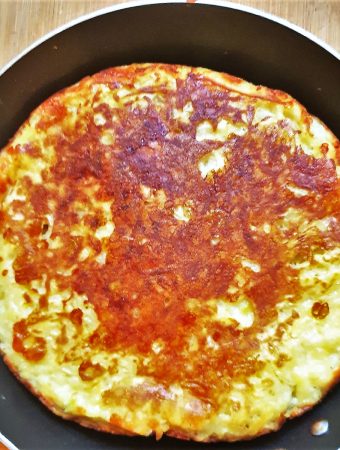 A potato frittata in a frying pan.