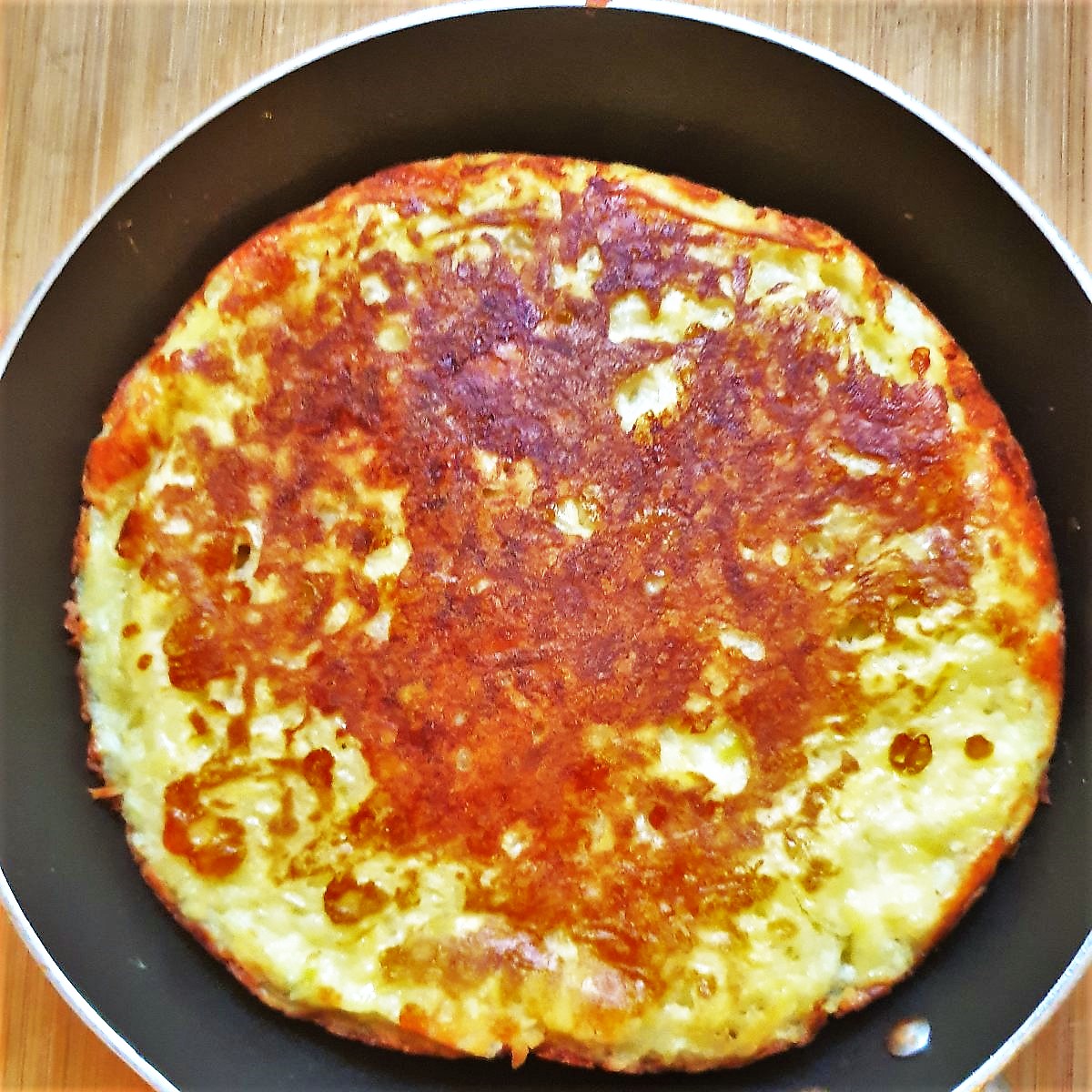 A potato frittata in a frying pan.