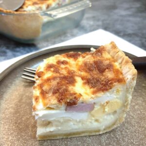 A slice of South African savoury tart on a plate.
