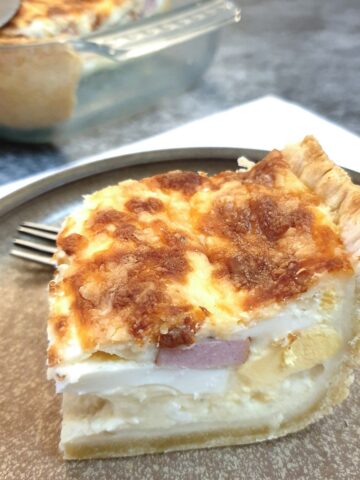 A slice of South African savoury tart on a plate.