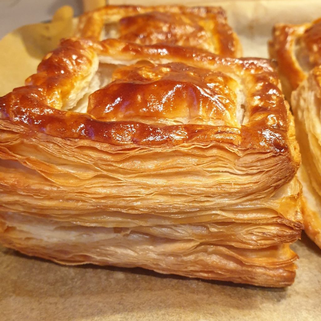 Close up of a golden brown vol-au-vent case showing the layers of pastry.