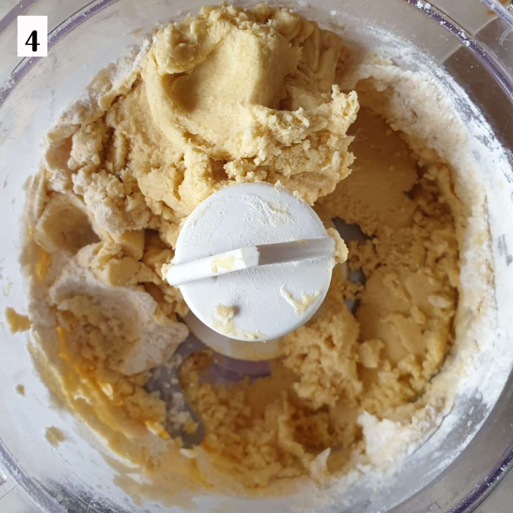 Sweetcrust pastry being mixed in a food processor.