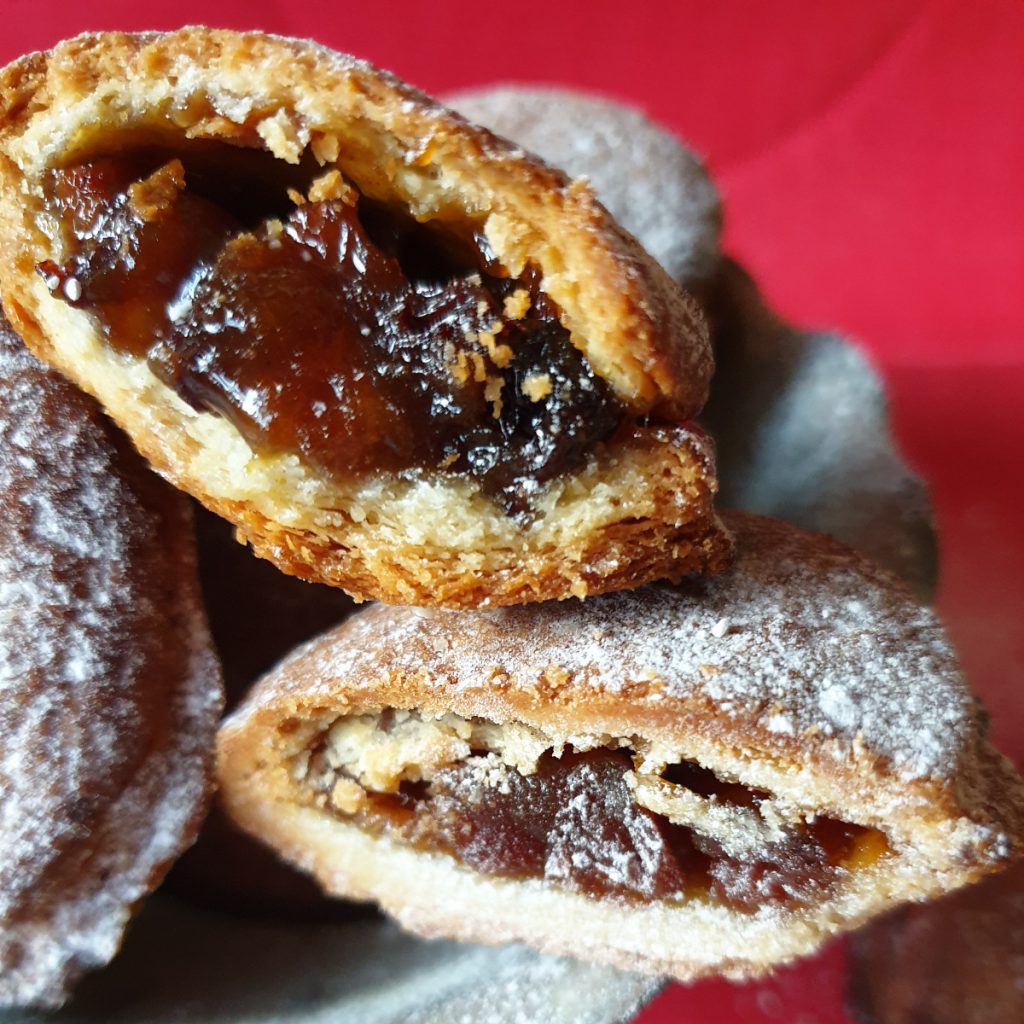 Close up of Christmas mince pies highlighting filling.