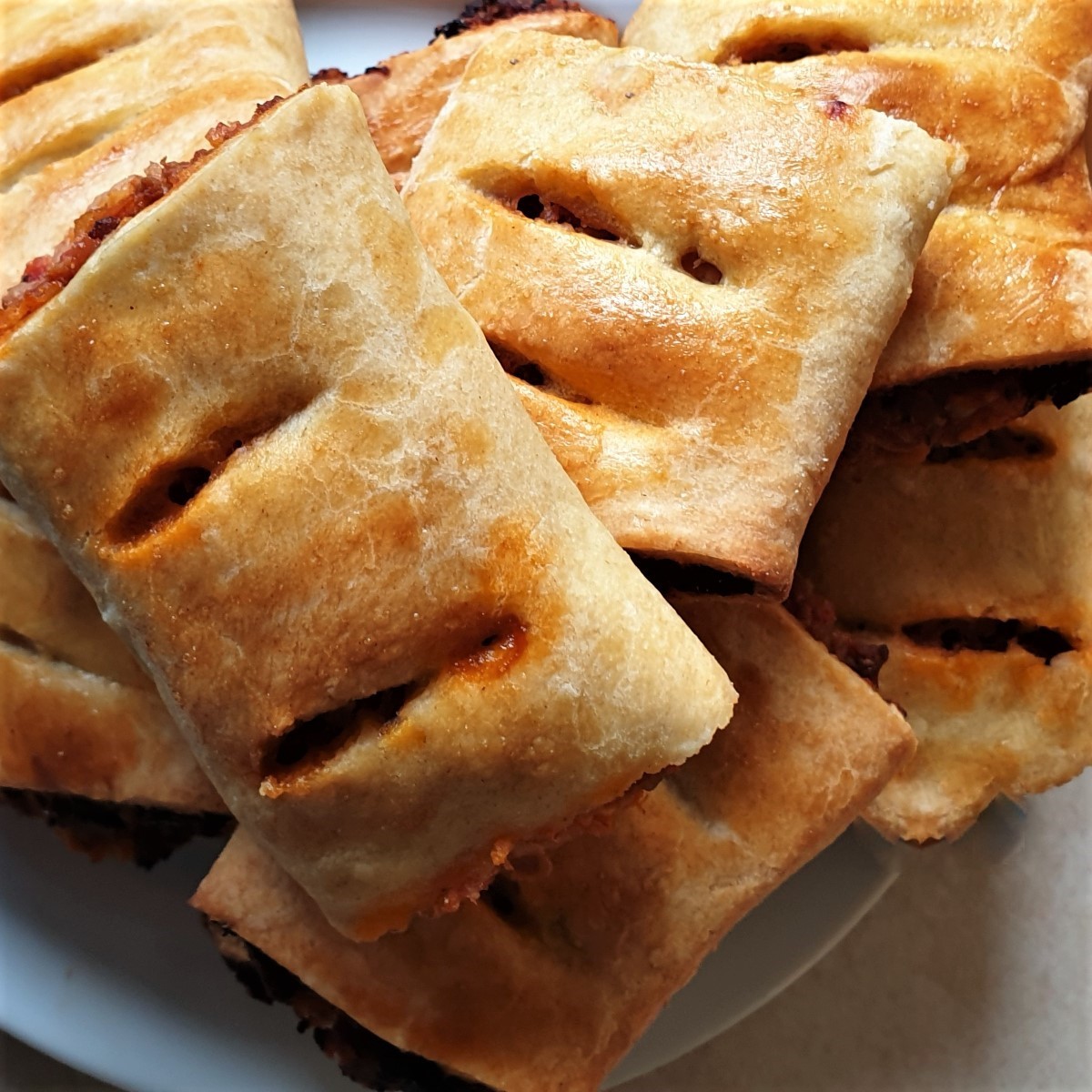 A pile of bolognese sausage rolls.