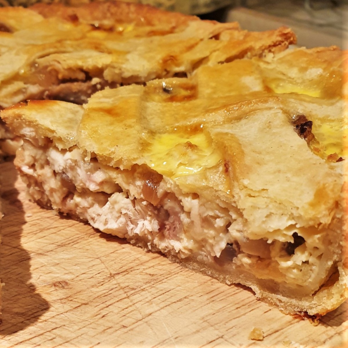 A slice of chicken and mushroom quiche.