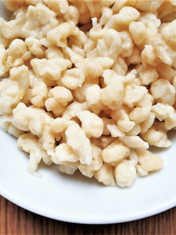 Close up of homemade spaetlze in a white dish.