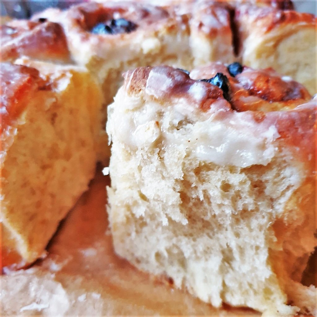 A closeup shot of a cinnamon bun showing the texture of the baked dough.