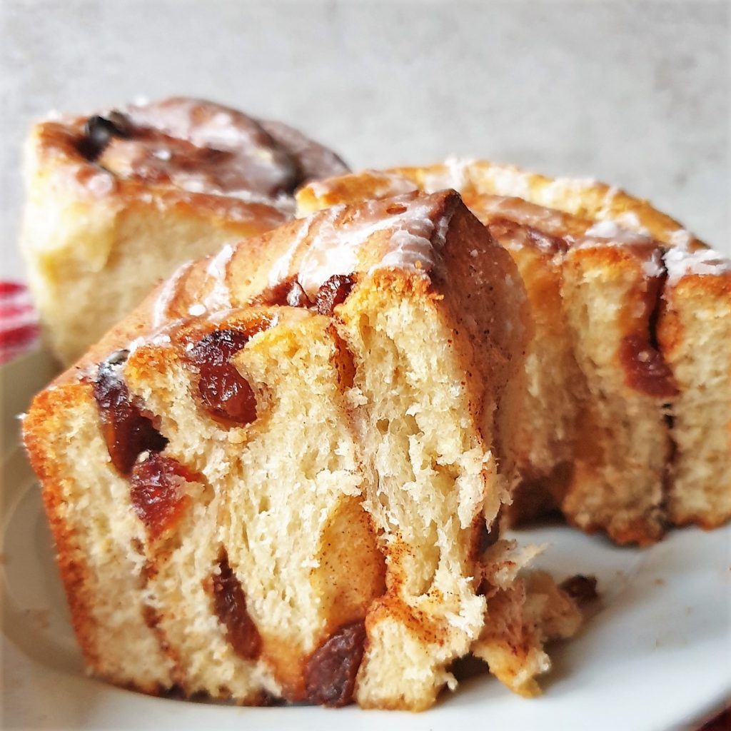 A chelsea bun cut in half to show the inside.