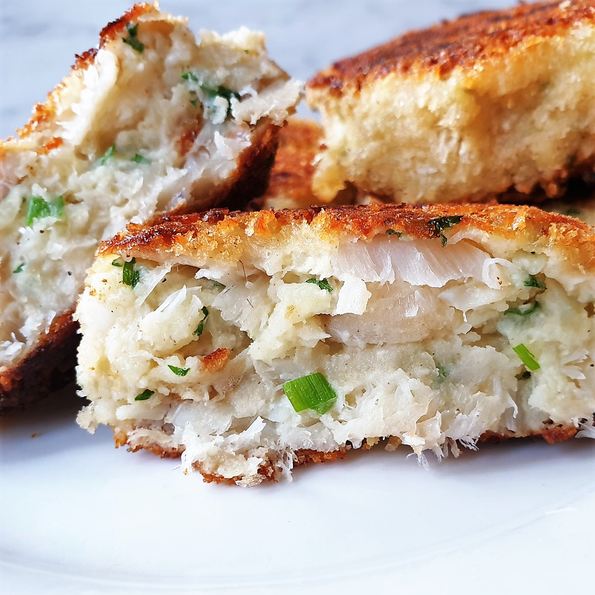 A homemade fishcake cut in half to show the inside.