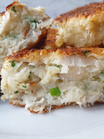 A homemade fishcake cut in half to show the inside.