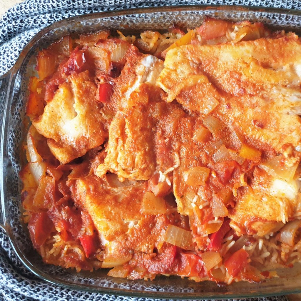 A baked dish of spicy fish and rice.