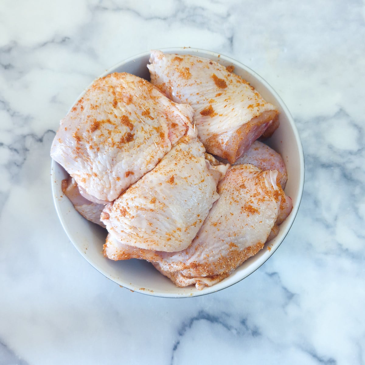 Chicken pieces coated with a spice rub.