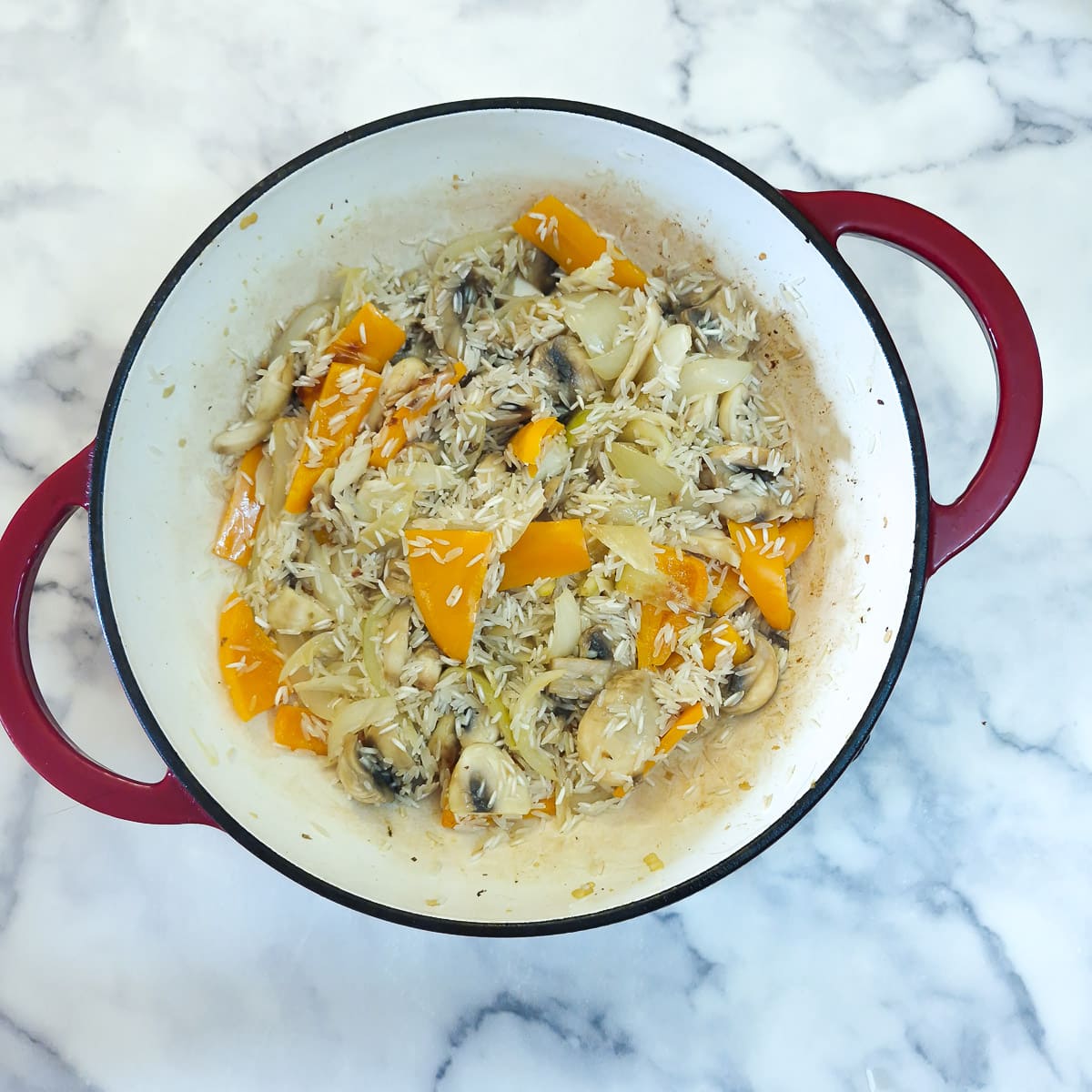 Raw rice stirred into the softened vegetables.
