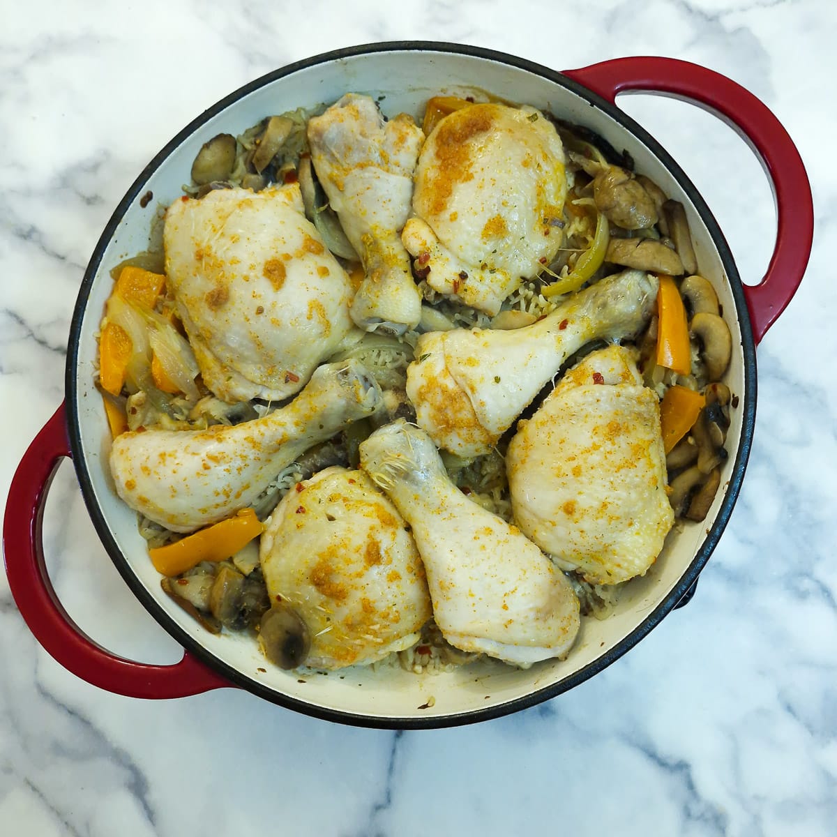 Cooked chicken pieces on to of the cooked rice.