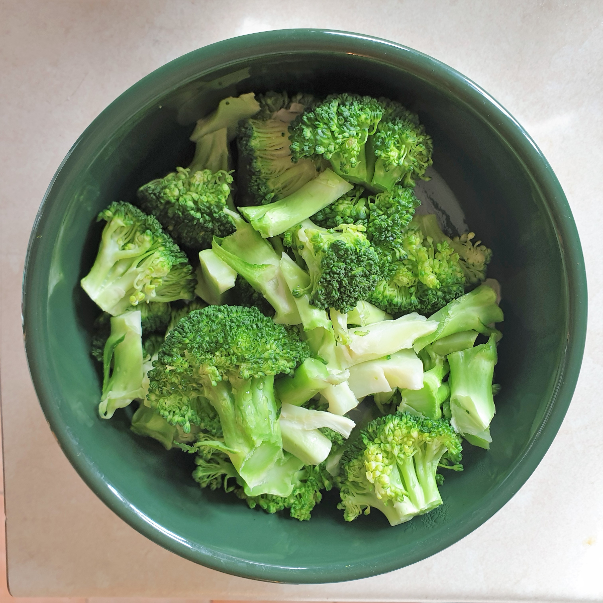 A dish of cooked broccoli florets.