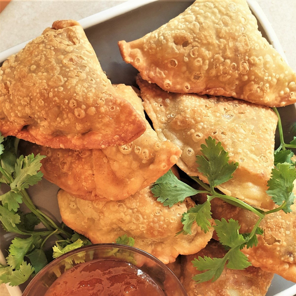 A plate of fried beef samosas.