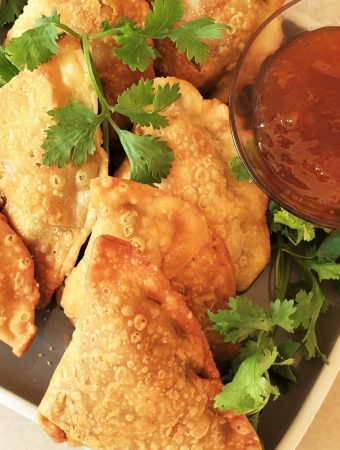 A plate of samosas with beef, pea and potato filling.