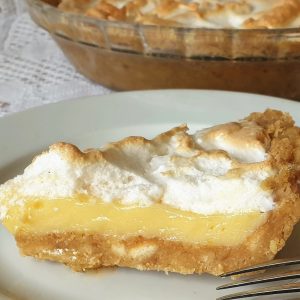 A slice of lemon meringue pie on a plate.