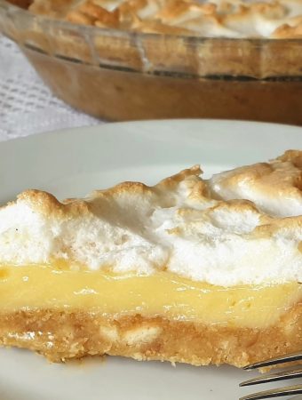 A slice of lemon meringue pie on a plate.