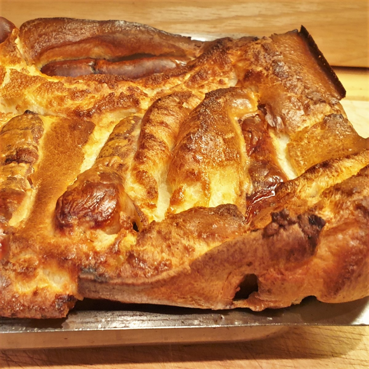 A dish of toad in the hole showing how well the batter has risen.