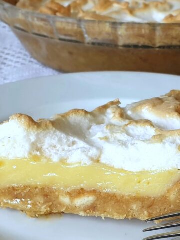 A slice of lemon meringue pie on a plate.