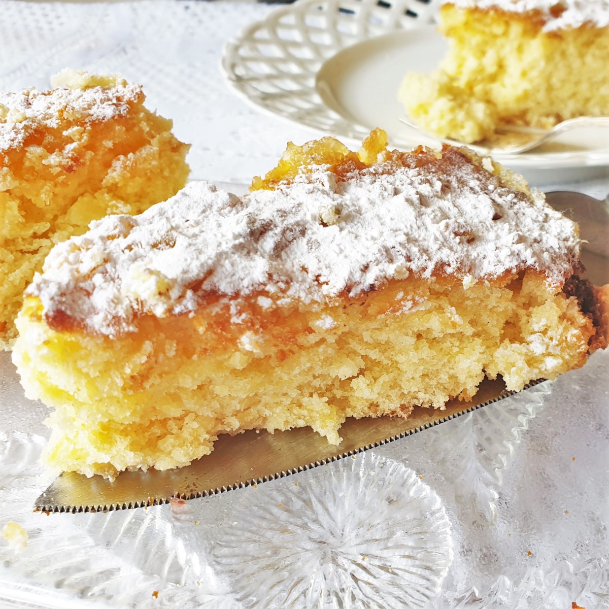 A closeup of a slice of pineapple coconut cake showing the texture.