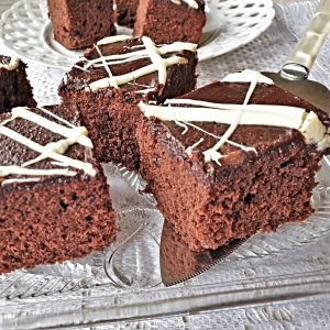 Squares of quick mix chocolate cake on a glass plate.