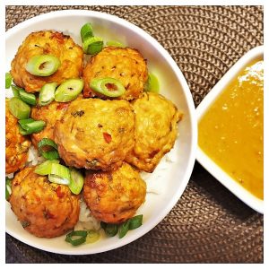 A dish of thai meatballs sprinkled with spring onions