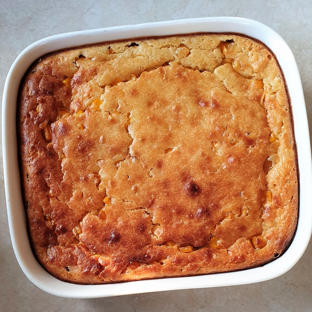 A dish of baked cornbread casserole.