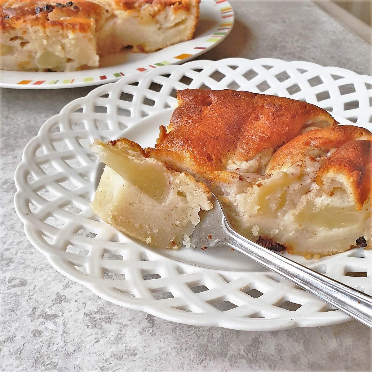 A slice of apple cake tray bake with a fork.