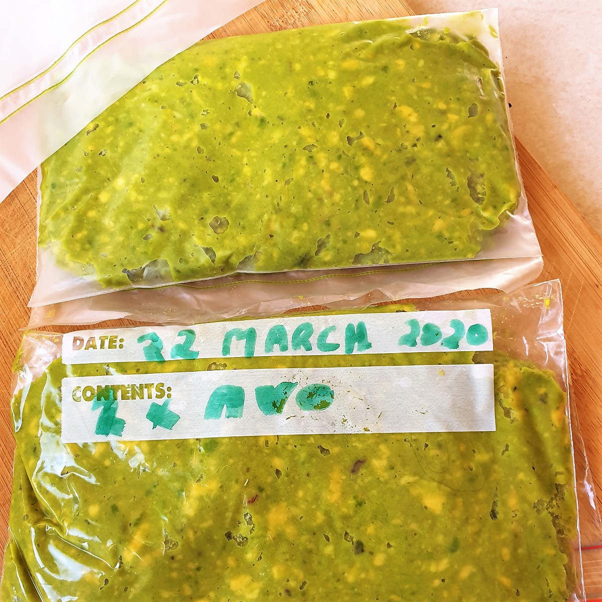 Mashed avocado packed into a freezer bag.