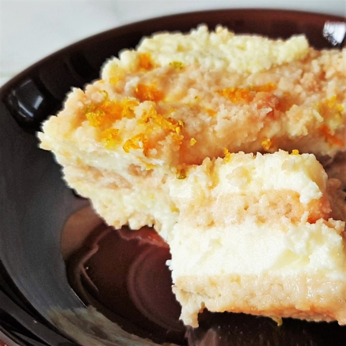 Close up of a slice of citrus cheesecake.