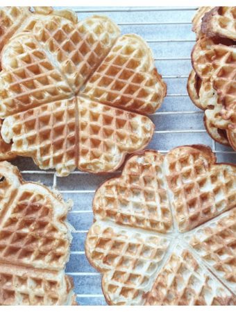 Waffles cooling on a wire rack.
