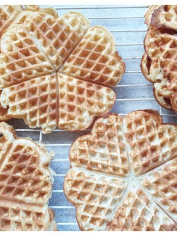 Waffles cooling on a wire rack.